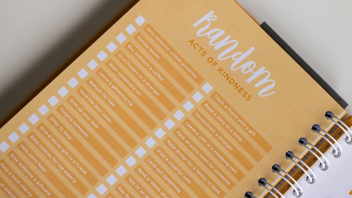 Owner using notebook to track dog development during group training class
